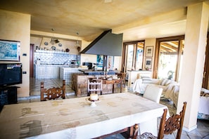 Enjoy a well-appointed kitchen with a central island, dining area, and cozy seating space.