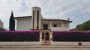 A two-story building with a central tower, a gated entrance, and a balcony. - Villa Nice Mondello  (Palermo)