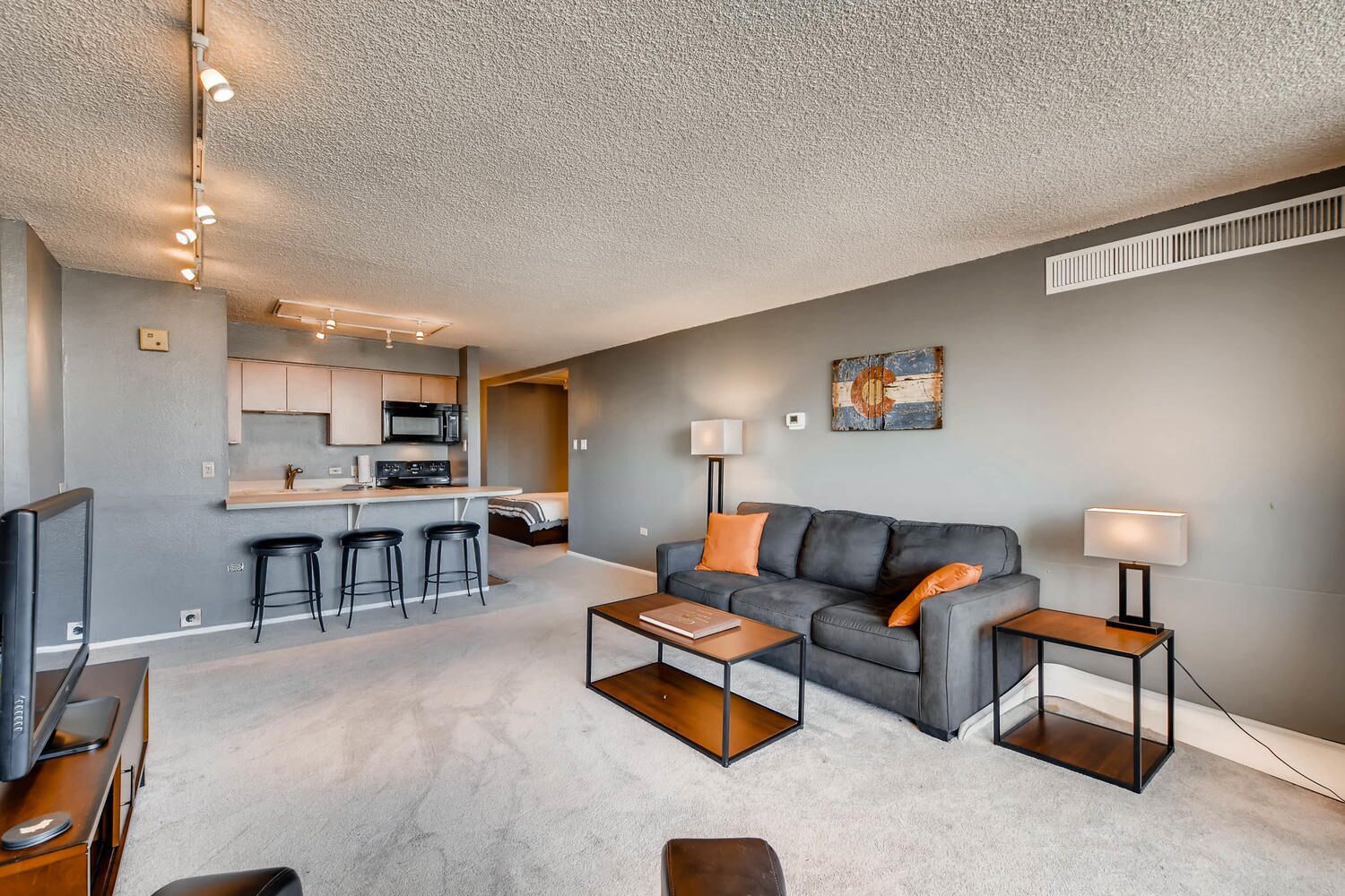 A modern apartment with a kitchen, living room, and dining area.