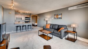 A modern apartment with a kitchen, living room, and dining area. - Furnished 35th Floor Condo In The Heart Of Downtown Denver (Denver)