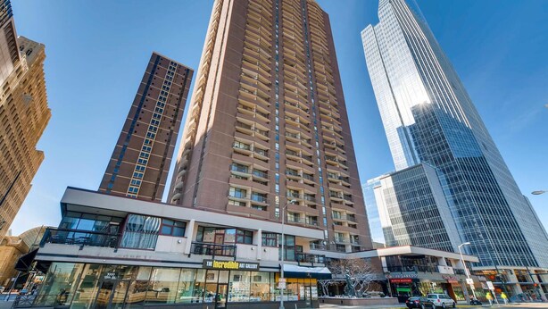 A high-rise building with a modern architectural design, featuring multiple balconies and a glass facade. - Furnished 35th Floor Condo In The Heart Of Downtown Denver (Denver)