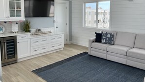 A modern kitchen with white cabinetry, a built-in oven, and a large window. - 4 Br, 2 Ba Penthouse Condo with Ocean View- Beach Block- Heart of Sea Isle City (Sea Isle City)