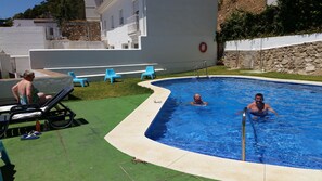 Alberca al aire libre y camastros