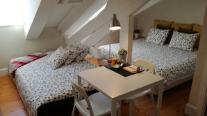 Een knus kamertje met een vide, een bureau met stoel en een tafel met een schaal fruit.
