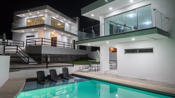 A modern two-story house with a swimming pool, outdoor seating, and a staircase leading to a balcony. - Dream house OCEAN VIEW San Carlos (SAN CARLOS)