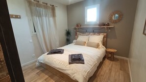 A bedroom with a bed, bedside table, and a window. - Pleasant house in Luberon with swimming pool, France (Viens)