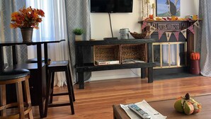 A living room with a TV, a fireplace, and a coffee table. - Baby Bear HideAway (Gatlinburg)