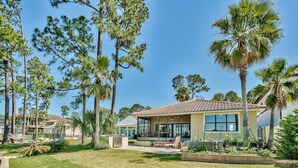 A residential property with a patio, outdoor seating, and a well-maintained lawn. - Destin Festival!!  Sept 24 - 28  Available (Miramar Beach)