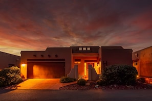 A modern house with a garage, a driveway, and a well-maintained front yard.