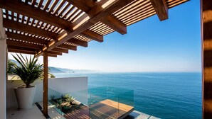 A modern balcony with a wooden pergola, a glass railing, and a view of the sea. - MODERN AND LUXURY OCEANFRONT VILLA (Puerto Vallarta)
