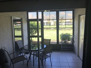 Enjoy al fresco dining with a view of the well-maintained lawn and surrounding buildings from this outdoor patio.
