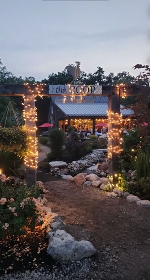 An entrance to a restaurant with a sign reading 'the COOP' and a rustic building in the background. - Relaxing Gem Beach, Close to Twin Oast Brewery, Orchard Eatery and Miller Ferry (Port Clinton)