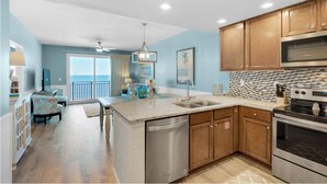 A kitchen with wooden cabinets, a stainless steel dishwasher, and a large oven.
