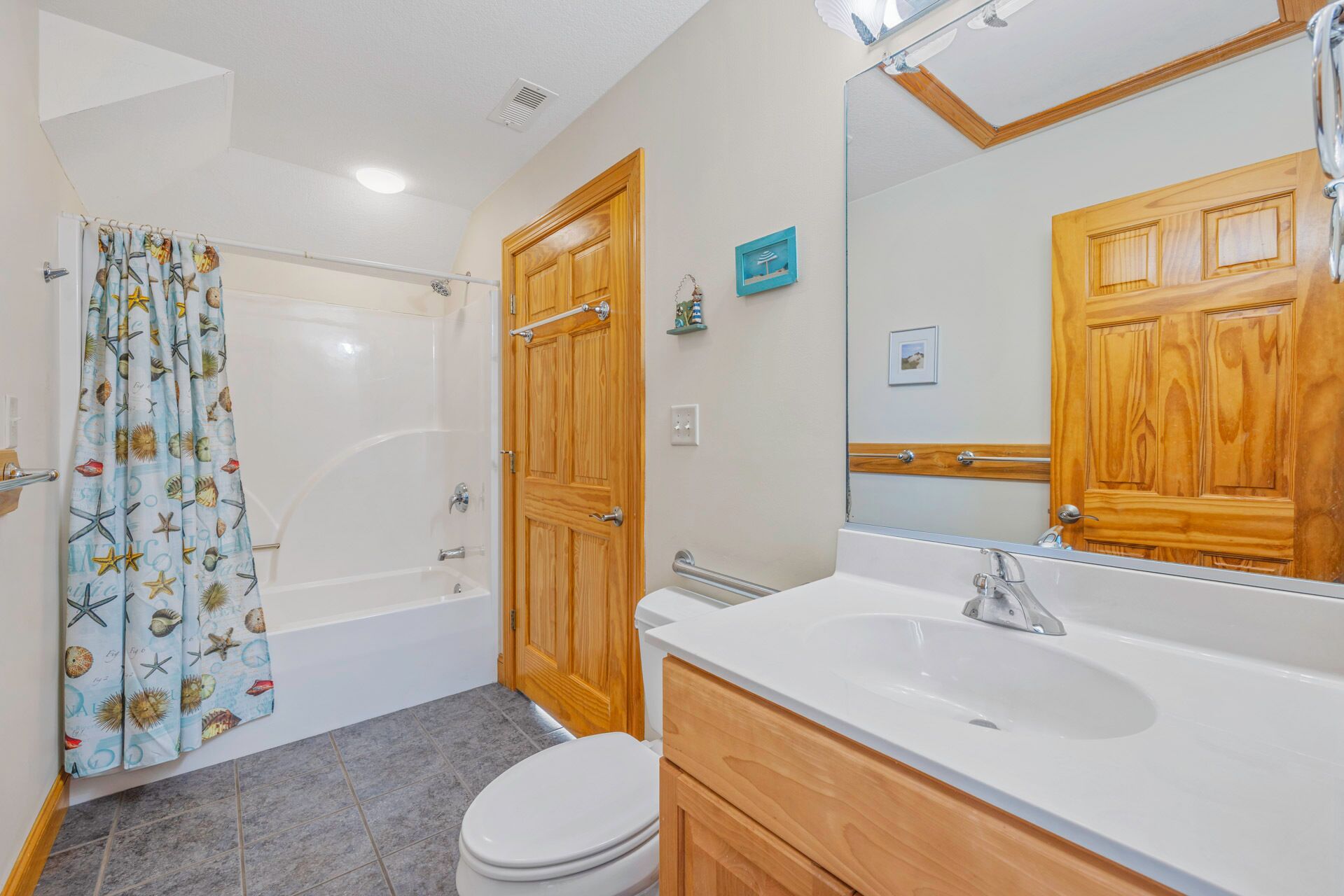 A bathroom with a bathtub, toilet, and sink.