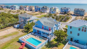 A coastal residential area with houses, a swimming pool, and a beach. - Semi-Oceanfront Home w/ Pool, Hot Tub, Elevator, Game Room, Home Theater (Avon)