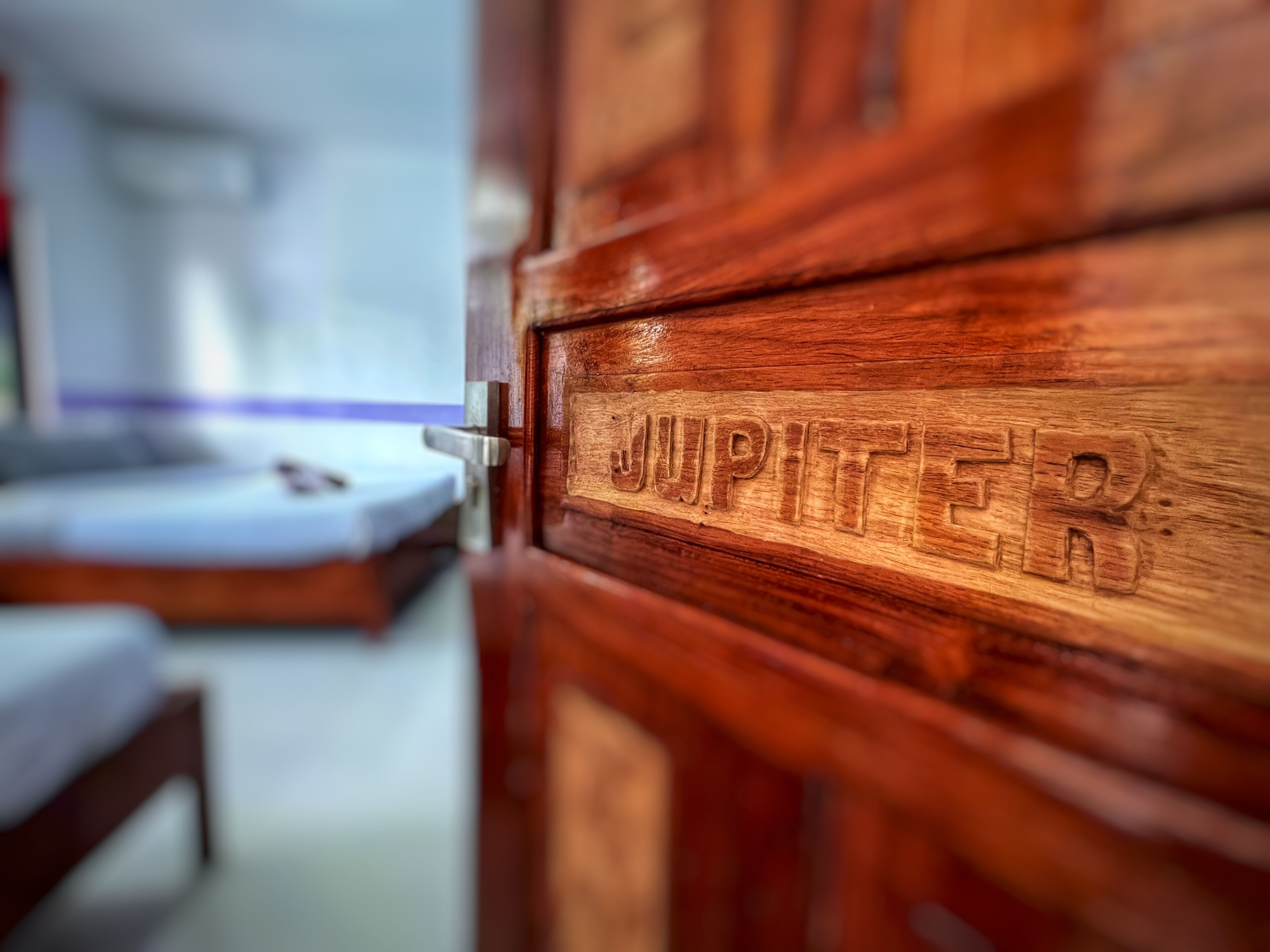 A wooden door with the word "JUPITER" carved into it.