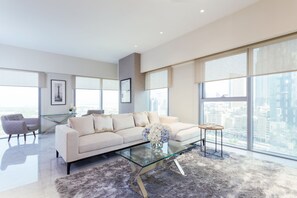 Comfort Apartment, 1 Bedroom, City View | Living area | 55-inch Smart TV with cable channels - Nasma Luxury Stays - Central Park Tower (Dubai)