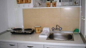 A kitchen with a sink, two electric fryers, a grater, and a window with a curtain. - Apartment in Zagreb with Terrace, Air condition, WIFI, Washing machine (3798-1) (Zagreb)