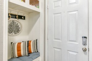 A white door with a keyhole and a doorbell.
