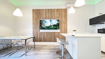 Deluxe Apartment, City View | Living area | 55-inch flat-screen TV with digital channels, TV