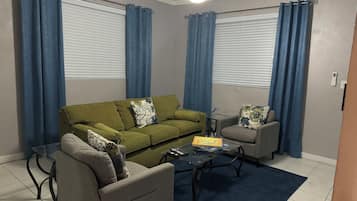 Deluxe Apartment, 1 King Bed with Sofa bed | Living area | 55-inch flat-screen TV with digital channels, pay films