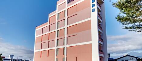 A multi-story building with a prominent sign on the side.
