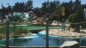 A water feature with a waterfall and a small pond, surrounded by rocks and greenery. - BRIGANTINE TOP LOCATION! WALK TO BEACH, EATERIES. 12 NOON CHECKOUT. DOGS OK (Brigantine)