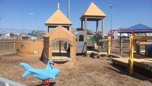 A playground with a climbing structure, a slide, and a playhouse. - BRIGANTINE TOP LOCATION! WALK TO BEACH, EATERIES. 12 NOON CHECKOUT. DOGS OK (Brigantine)