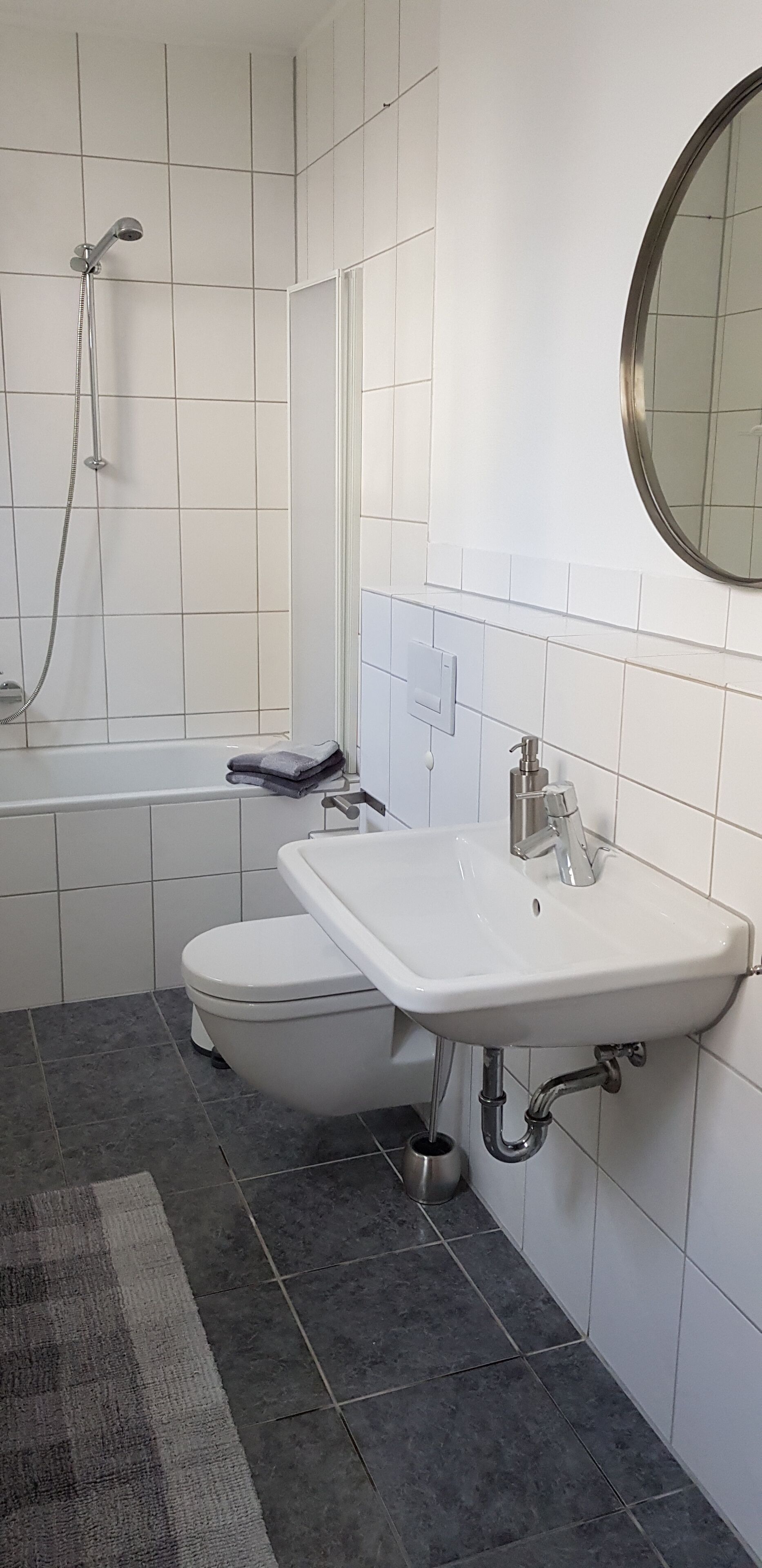 Ein Badezimmer mit Toilette, Waschbecken und Dusche.