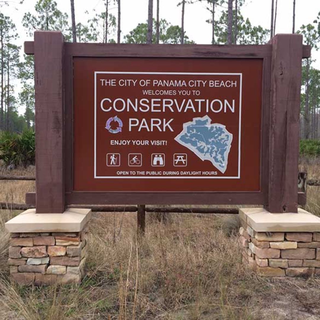 A sign for Panama City Beach Conservation Park welcoming visitors.