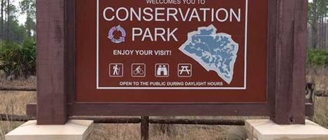 A sign for Panama City Beach Conservation Park welcoming visitors.