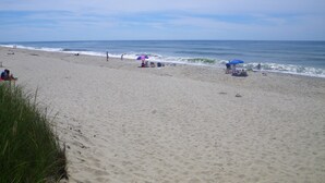 A beach with sand, waves, and a clear sky. - Cute, Quiet, Comfortable, Centrally Located, Outdoor Shower, Large Yard, BBQ (Nantucket)