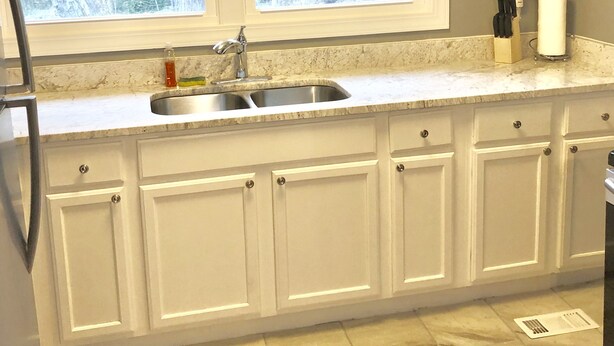 A kitchen with two windows, a sink, and cabinets. - Swamp Rabbit Retreat (Travelers Rest)