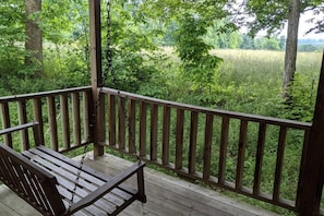 View of field from back porch of Hippy HIll deluxe camping cabin #8