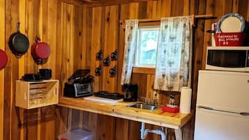 Fridge, microwave, coffee/tea maker, cookware/dishes/utensils