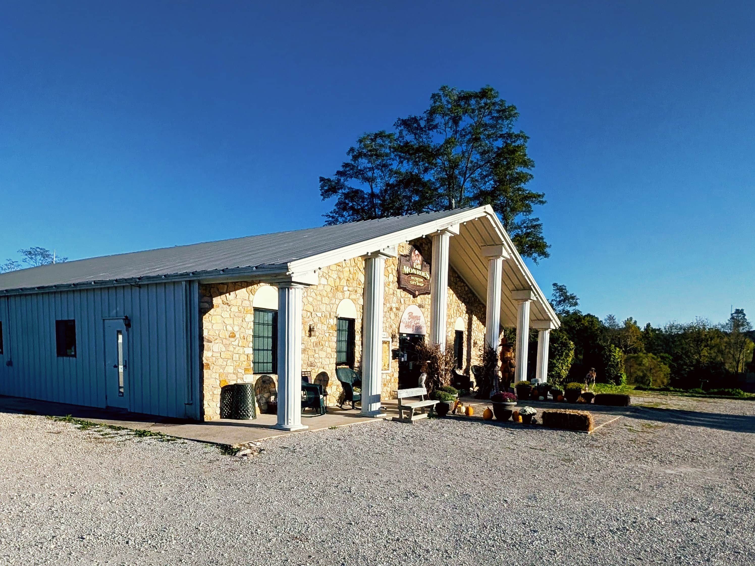 A building with a stone facade and a covered porch.