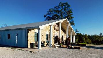 A building with a stone facade and a covered porch.