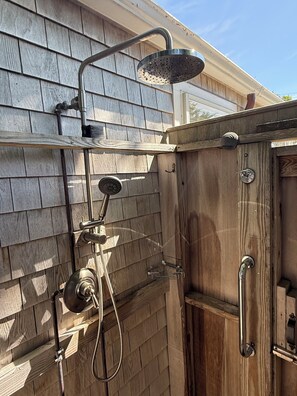 A wooden exterior wall with a metal showerhead and hose. - IN TOWN-  High quality luxury spacious home - walk to town - convenient location (Nantucket)