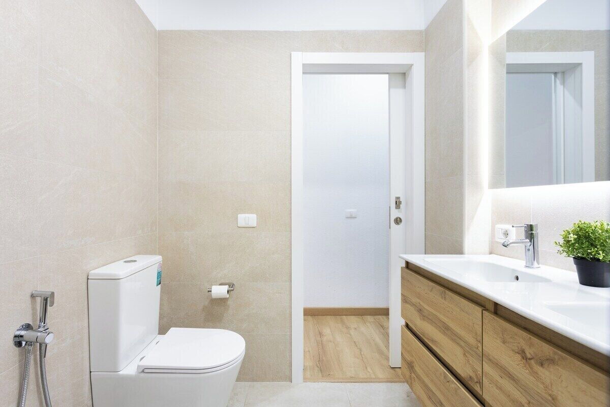 A modern bathroom with a toilet, bidet, and sink.