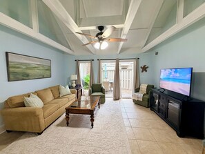 A living room with a sofa, armchair, coffee table, television, and a ceiling fan. - Best Queens Grant location: easy walk to all amenities.   (Hilton Head Island)