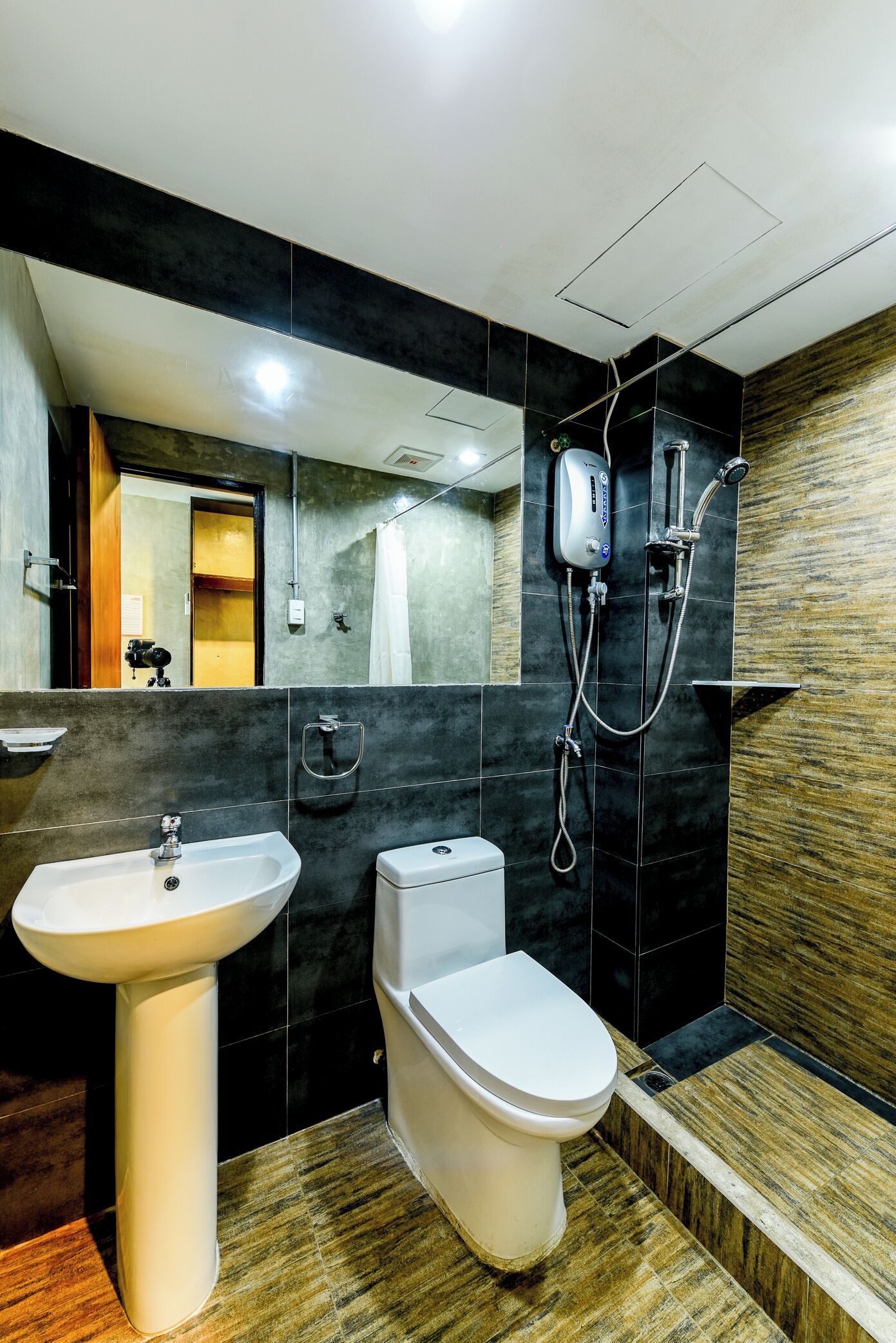 A modern bathroom with a sink, toilet, and shower.