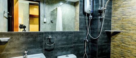 A modern bathroom with a sink, toilet, and shower.