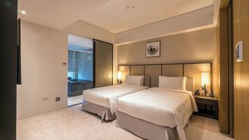 A hotel room with two beds, a large window, and a view of the city.