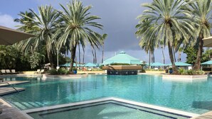 A pool area with lounge chairs and palm trees. - AMAZING Westin St John!!  3 BD/3 BA Villa (Great Cruz Bay)