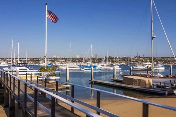 Boats docked at the marina, accessible via a walkway.