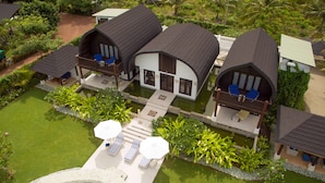 A resort with multiple villas, a swimming pool, and a well-maintained garden.