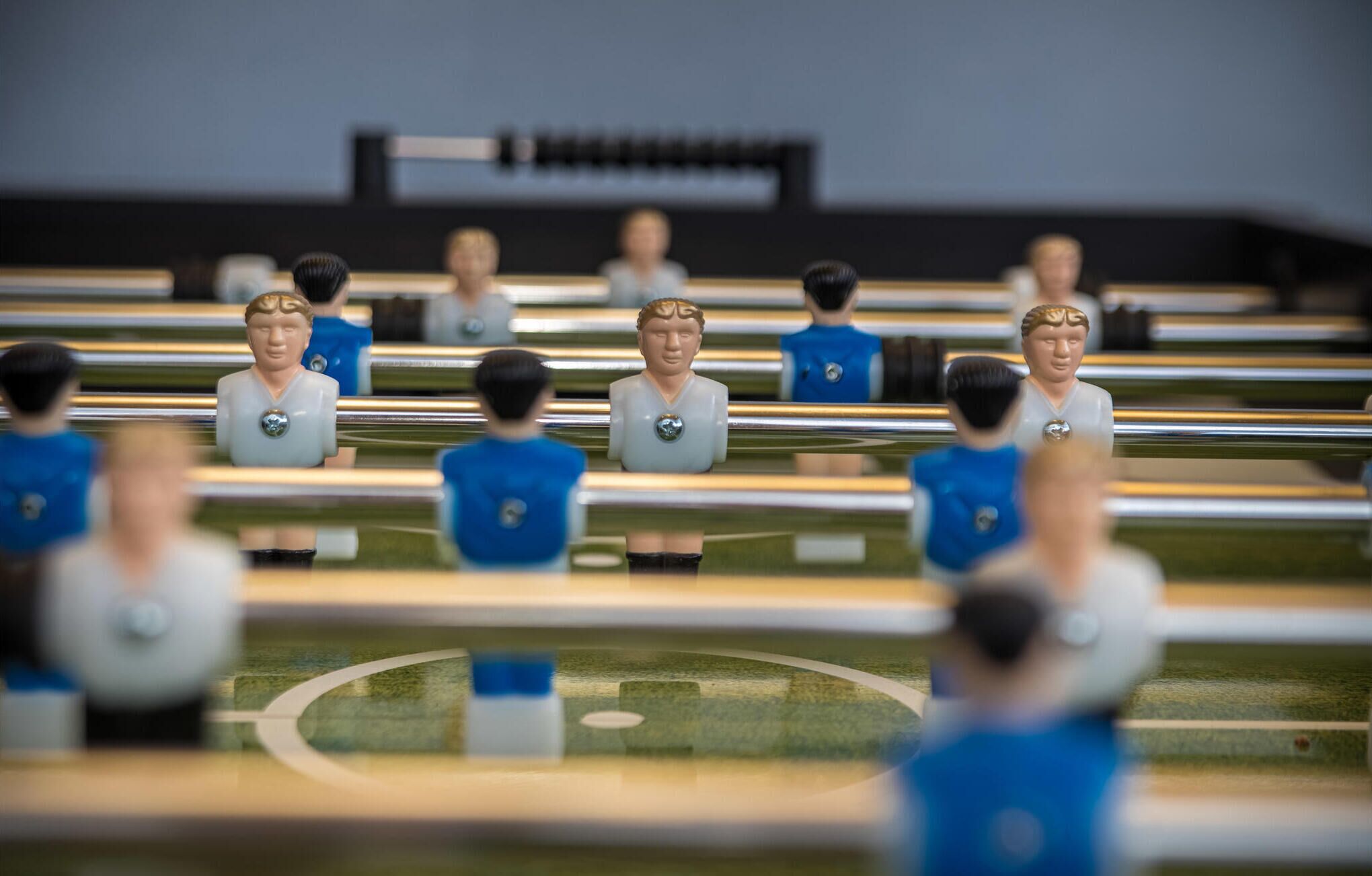 A row of seated figures in a stadium setting.