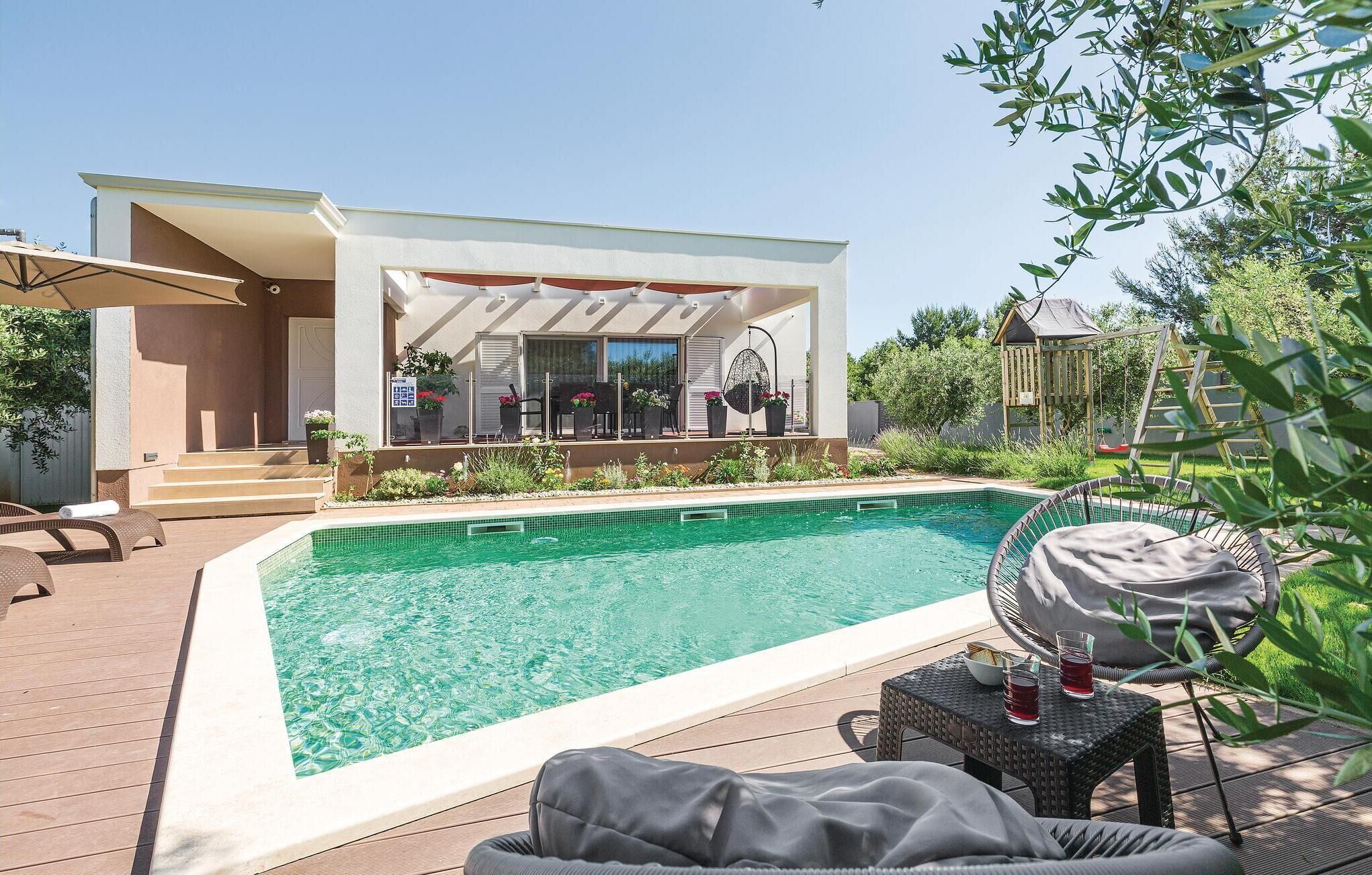 A swimming pool with lounge chairs and a covered patio area.