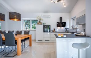 Fridge, stovetop, dishwasher, coffee/tea maker