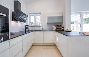 Fridge, stovetop, dishwasher, coffee/tea maker